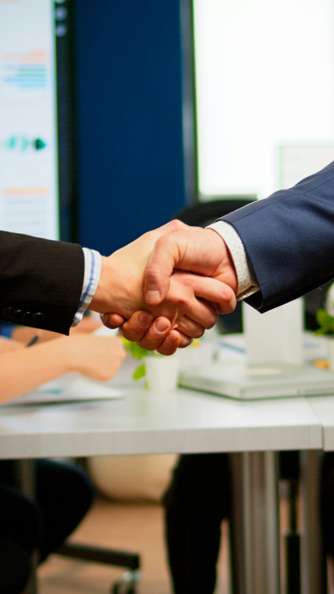 Satisfied businessman company employer wearing suit handshake new employee